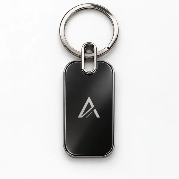 Small rectangle metal keychain in silver-black with a geometric logo